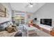 Inviting living room featuring a balcony, comfortable seating, and a modern entertainment setup at 8303 Santa Fe Pkwy, Atlanta, GA 30350