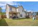 A spacious backyard featuring a patio with outdoor furniture, a barbecue grill, and a playground area at 1297 Partridge Ln, Riverdale, GA 30296