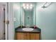 Cozy bathroom with a single sink vanity, bright lighting and neutral wall paint at 1297 Partridge Ln, Riverdale, GA 30296