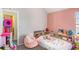 Charming bedroom featuring a cozy reading nook, a colorful bedspread, and playful decor at 1297 Partridge Ln, Riverdale, GA 30296