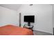 A bedroom with a TV and white vaulted ceilings above an orange bedspread at 1297 Partridge Ln, Riverdale, GA 30296
