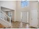 Bright foyer with high ceilings, tile flooring, a staircase, and a large window allowing natural light at 1297 Partridge Ln, Riverdale, GA 30296