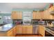 Updated kitchen with stainless steel appliances and granite countertops open to dining area at 1297 Partridge Ln, Riverdale, GA 30296