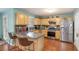 Well-lit kitchen with stainless steel appliances, wooden cabinets, and sleek countertops at 1297 Partridge Ln, Riverdale, GA 30296