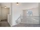 Bright upstairs landing with white railing and large window, carpeted floor at 1297 Partridge Ln, Riverdale, GA 30296