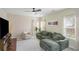 Comfortable living room with a cozy sofa, a ceiling fan, and large windows offering plenty of natural light at 1297 Partridge Ln, Riverdale, GA 30296