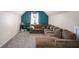 Comfortable living room with a plush sectional sofa, neutral carpet, and a stylish blue accent wall at 1297 Partridge Ln, Riverdale, GA 30296