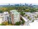 Stunning aerial view of a luxurious condo building with a vibrant city skyline backdrop at 3820 Roswell Ne Rd # 902, Atlanta, GA 30342
