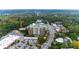Beautiful aerial view showcases a brick apartment building with green roofing nestled among trees and roads at 3820 Roswell Ne Rd # 902, Atlanta, GA 30342