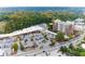 Aerial shot of the brick apartment building and surrounding businesses along the highway with lush surroundings at 3820 Roswell Ne Rd # 902, Atlanta, GA 30342