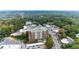 Stunning aerial view of a brick apartment building surrounded by lush greenery and a bustling cityscape at 3820 Roswell Ne Rd # 902, Atlanta, GA 30342