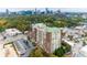Aerial view showcasing building with city skyline and lush green trees surrounding it at 3820 Roswell Ne Rd # 902, Atlanta, GA 30342