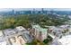 Beautiful aerial image shows a brick apartment building backed by downtown city skyline and lush foliage at 3820 Roswell Ne Rd # 902, Atlanta, GA 30342