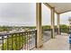 Balcony with black wrought iron railing overlooking tree lined street and city buildings at 3820 Roswell Ne Rd # 902, Atlanta, GA 30342