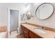 Bathroom featuring an extended double vanity with decorative mirrors and fixtures at 3820 Roswell Ne Rd # 902, Atlanta, GA 30342