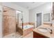 Bright bathroom featuring a tiled shower, separate tub, and double vanity sinks at 3820 Roswell Ne Rd # 902, Atlanta, GA 30342