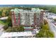 Charming brick apartment building with balconies and a pool, surrounded by lush greenery and city views at 3820 Roswell Ne Rd # 902, Atlanta, GA 30342