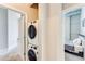 Laundry room featuring stacked washer and dryer with a view into the bedroom next door at 3820 Roswell Ne Rd # 902, Atlanta, GA 30342