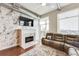 Inviting living room with a fireplace, hardwood floors, and natural light at 3820 Roswell Ne Rd # 902, Atlanta, GA 30342