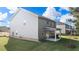 The backyard features a covered patio, green lawn, and views of neighboring homes at 636 Kimberwick Dr, Locust Grove, GA 30248