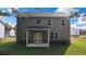 The backyard features a covered patio, green lawn and neighboring home views at 636 Kimberwick Dr, Locust Grove, GA 30248