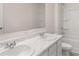 Bathroom featuring double sinks, a marble countertop, and a bathtub with shower at 636 Kimberwick Dr, Locust Grove, GA 30248