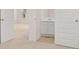 Bathroom sink and vanity view with neutral paint tones and white doors at 636 Kimberwick Dr, Locust Grove, GA 30248
