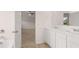 Primary bathroom showcasing a double vanity, and entry to the primary bedroom at 636 Kimberwick Dr, Locust Grove, GA 30248