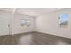 Open-concept room featuring neutral paint, large windows and new floors at 636 Kimberwick Dr, Locust Grove, GA 30248
