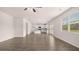 Open-concept living room featuring wood floors, a ceiling fan, and an adjacent kitchen at 636 Kimberwick Dr, Locust Grove, GA 30248