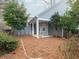 View of the home's siding, covered patio, and private backyard at 3036 Lassiter Rd, Marietta, GA 30062