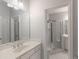 Clean bathroom featuring white cabinetry, a large mirror, and a glass-enclosed shower at 3036 Lassiter Rd, Marietta, GA 30062