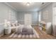 Serene bedroom with soft blue walls, plush bedding, and ample toy storage at 3036 Lassiter Rd, Marietta, GA 30062