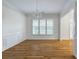 Bright dining room featuring a chandelier, hardwood floors, and large windows at 3036 Lassiter Rd, Marietta, GA 30062
