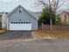 Home exterior featuring a two-car garage, blue siding and manicured lawn at 3036 Lassiter Rd, Marietta, GA 30062