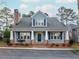 Charming home with a brick chimney, a cozy front porch, and manicured landscaping at 3036 Lassiter Rd, Marietta, GA 30062