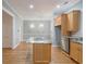 Spacious kitchen with marble countertops, an island cooktop, and modern lighting at 3036 Lassiter Rd, Marietta, GA 30062