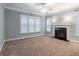 Spacious living room with a fireplace, neutral carpet, and large windows at 3036 Lassiter Rd, Marietta, GA 30062
