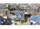 Aerial view of a two-story home with mature trees, a well-manicured lawn, and a charming front porch at 1712 Green Farm Cir, Dacula, GA 30019
