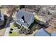 Overhead view of a two-story home boasting well-manicured landscaping, including shrubs, trees and a paved walkway at 1712 Green Farm Cir, Dacula, GA 30019