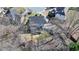 Aerial view of a two-story home with a deck, set amidst mature trees and a green lawn in a residential area at 1712 Green Farm Cir, Dacula, GA 30019