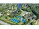 Wide aerial shot showcases the community's tennis courts, pool, playground, and picturesque lake in a serene setting at 1712 Green Farm Cir, Dacula, GA 30019