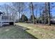 Expansive backyard featuring green lawn, mature trees, and a deck, perfect for outdoor activities and relaxation at 1712 Green Farm Cir, Dacula, GA 30019
