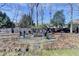 Landscaped backyard with a fire pit and seating area at 1712 Green Farm Cir, Dacula, GA 30019