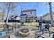 Backyard with a fire pit, chairs, privacy fence, deck and a two-story house in the background at 1712 Green Farm Cir, Dacula, GA 30019