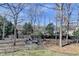 Large backyard with a fire pit and mature trees at 1712 Green Farm Cir, Dacula, GA 30019