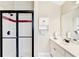 Bright bathroom featuring a glass-enclosed shower with dark trim, and a single sink vanity with storage at 1712 Green Farm Cir, Dacula, GA 30019
