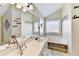 Well-appointed bathroom with a soaking tub, double sink vanity, a large mirror, and decorative wall art at 1712 Green Farm Cir, Dacula, GA 30019