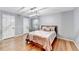 Bedroom with modern light fixture, wood floor, and bright light at 1712 Green Farm Cir, Dacula, GA 30019