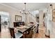 Spacious dining room with hardwood floors, chandelier, and adjacent staircase at 1712 Green Farm Cir, Dacula, GA 30019